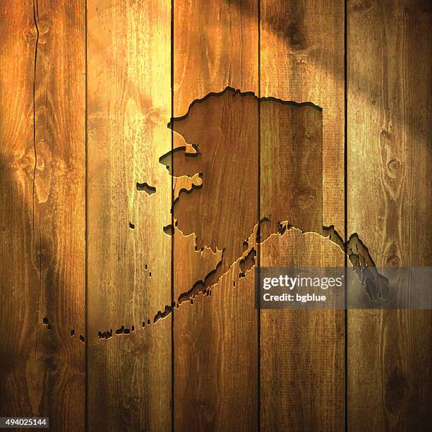 alaska map on lit wooden background - anchorage alaska stock illustrations
