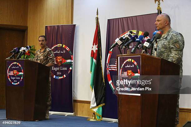 Major General Robert G. Catalanotti , the director, exercises and training, USCENTCOM, and Jordanian Brigadier General/Armor Fahad Al-Damen hold a a...