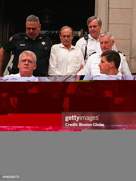 Dr. Dirk Greineder is escorted out of the courthouse at Norfolk Superior Court in Dedham, Mass. On June 29 moments after he was convicted of of...