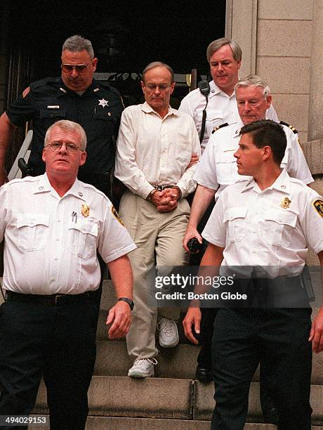 Dr. Dirk Greineder is escorted out of the courthouse at Norfolk Superior Court in Dedham, Mass. On June 29 moments after he was convicted of of...