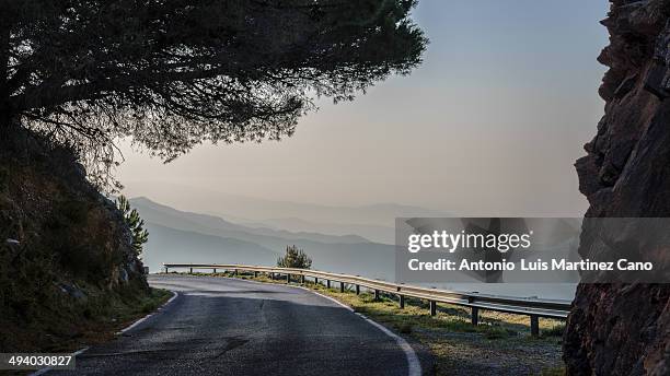 sunrise on mountain road. - crash barrier stock pictures, royalty-free photos & images