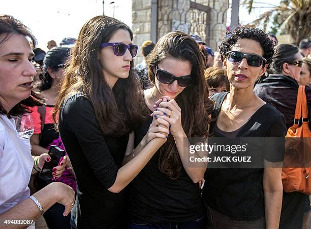 Shira and Ayelet Riva mourn during the funeral of their parents, Emanuel and Miriam, who were killed during the shooting attack at the Jewish Museum...