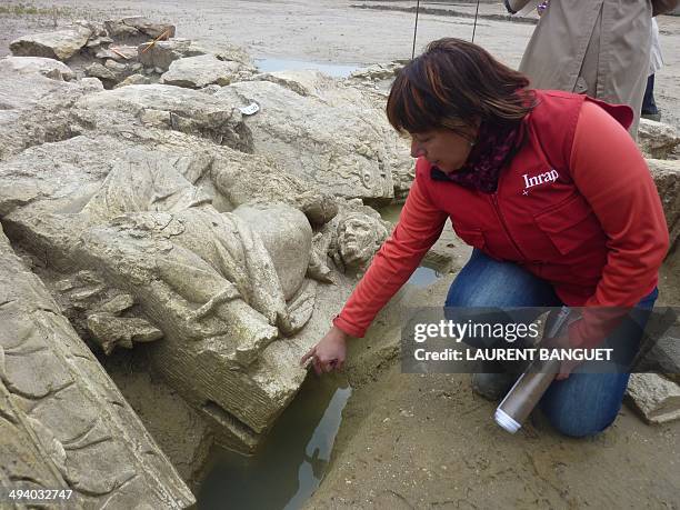 French archeologist Veronique Brunet-Gaston shows a recently uncovered Roman sculpture at the Inrap excavation site in Pont-Sainte-Maxence, north of...