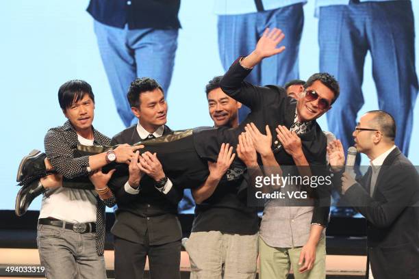 Actors Dominic Lam, Lam Ka Tung, Lau Ching-Wan and Alex Fong hold Louis Koo during "Overheard 3" premiere at Tsinghua University on May 27, 2014 in...