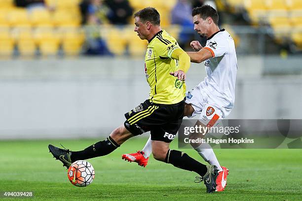 Ben Sigmund of the Phoenix attempts to block the shot of Jamie Maclaren of the Roar during the round three A-League match between the Wellington...