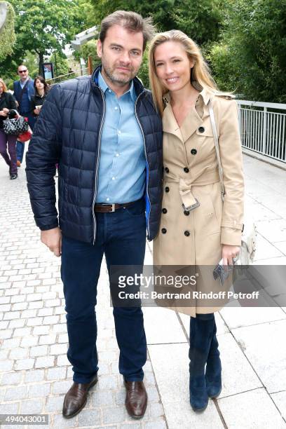 Actors Clovis Cornillac and his wife Lilou Fogli attend the Roland Garros French Tennis Open 2014 - Day 3 on May 27, 2014 in Paris, France.
