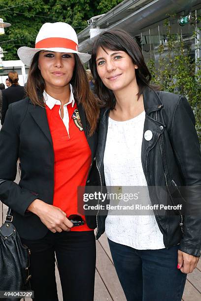 Hosts Karine Ferry and Estelle Denis attend the Roland Garros French Tennis Open 2014 - Day 3 on May 27, 2014 in Paris, France.