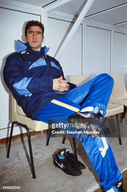 Substitute Leeds United forward Eric Cantona looks on from the bench prior to making his Leeds debut during the League Division One match between...