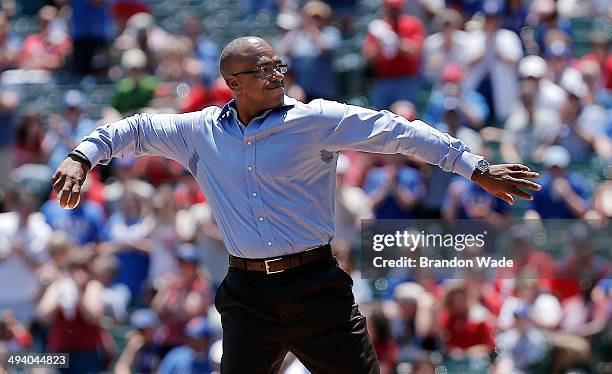 Former Texas Rangers player Julio Franco throws a ceremonial first pitch before the start of a baseball game against the Toronto Blue Jays at Globe...