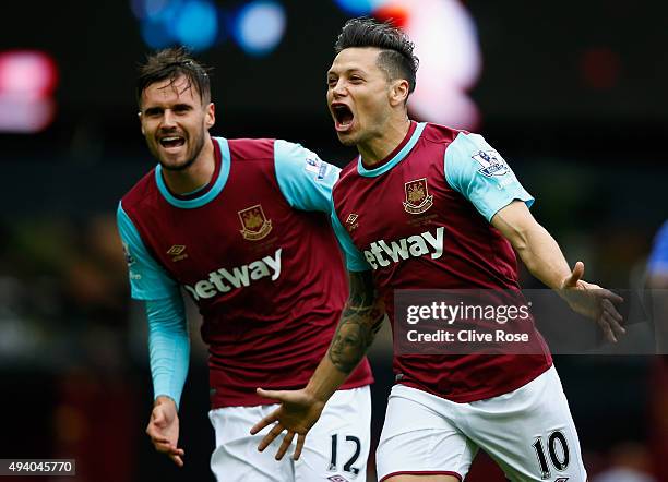 Mauro Zarate of West Ham United celebrates scoring his team's first goal with his team mate Carl Jenkinson during the Barclays Premier League match...