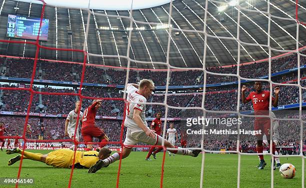 Arjen Robben of Muenchen scores his team's first goal past goalkeeper Timo Horn of Koeln during the Bundesliga match between FC Bayern Muenchen and...