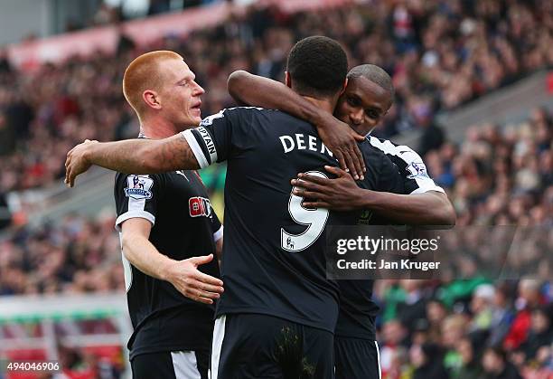 Troy Deeney of Watford celebrates scoring his team's first goal with his team mates Ben Watson and Odion Ighalo during the Barclays Premier League...