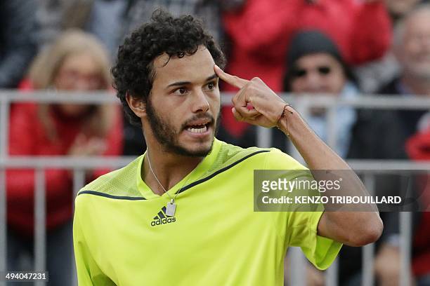 France's Laurent Lokoli reacts during his French tennis Open first round match against USA's Steve Johnson at the Roland Garros stadium in Paris on...