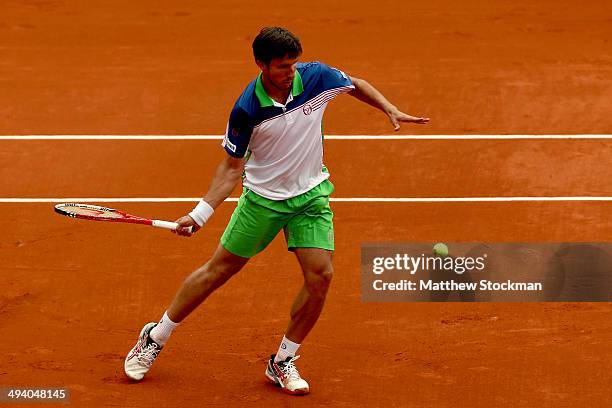 Igor Sijsling of Netherlands returns a shot during his men's singles match against David Ferrer of Spain on day three of the French Open at Roland...