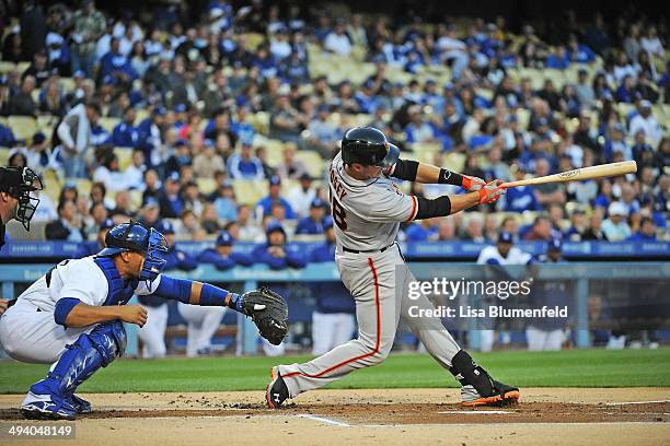 Buster Posey of the San Francisco Giants hits a single against the Los Angeles Dodgers at Dodger Stadium on May 9, 2014 in Los Angeles, California.