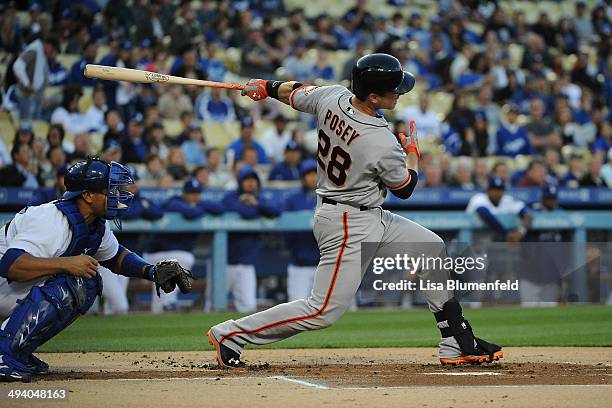 Buster Posey of the San Francisco Giants hits a single against the Los Angeles Dodgers at Dodger Stadium on May 9, 2014 in Los Angeles, California.