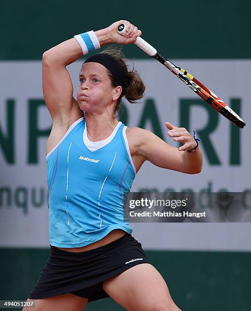 Lourdes Dominguez Lino of Spain returns a shot during her women's singles match against Casey Dellacqua of Australia on day three of the French Open...