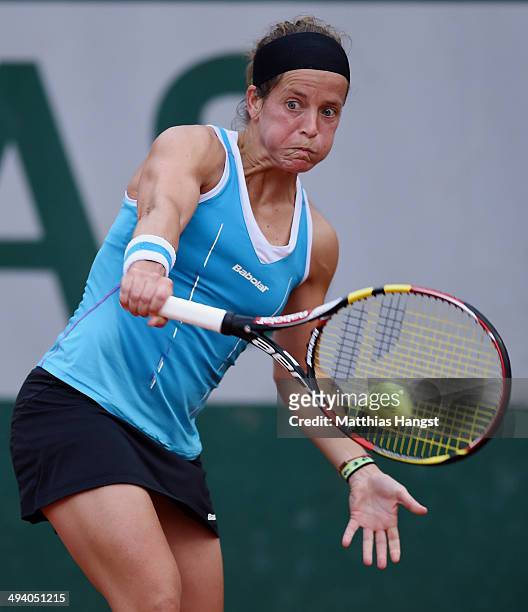 Lourdes Dominguez Lino of Spain returns a shot during her women's singles match against Casey Dellacqua of Australia on day three of the French Open...