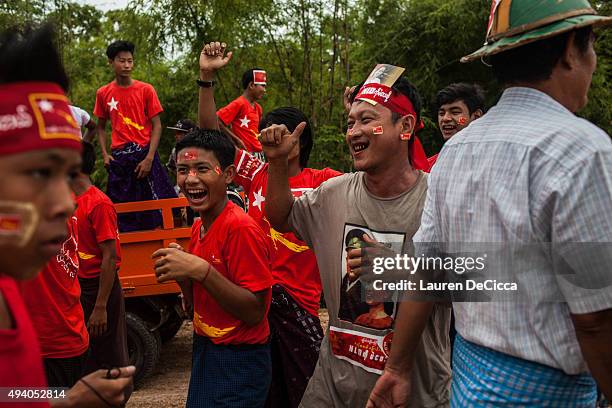 Supporters of Aung Sun Suu Kyi, leader of Myanmar's National League for Democracy Party, celebrate her arrival during her campaign period on October...