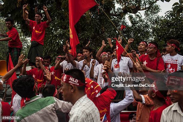 Supporters of Aung Sun Suu Kyi, leader of Myanmar's National League for Democracy Party, celebrate her arrival during her campaign period on October...
