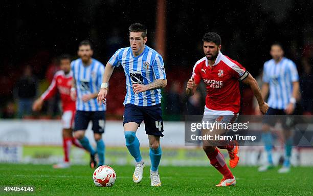 Romain Vincelot of Coventry City is tackled by Yaser Kasim of Swindon Town during the Sky Bet League One match between Swindon Town and Coventry City...