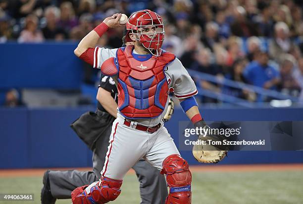 Wil Nieves of the Philadelphia Phillies throws out the baserunner at first base in the fourth inning during MLB game action against the Toronto Blue...