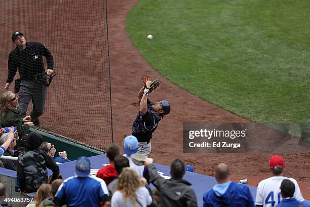 Michael McKenry of the Colorado Rockies catches a foul ball against the Kansas City Royals at Kauffman Stadium on May 14, 2014 in Kansas City,...