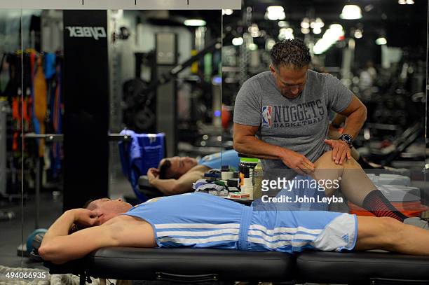 Denver Nuggets assistant coach/strength and conditioning Steve Hess works on Danilo Gallinari before his workout in the training room. Denver Nuggets...