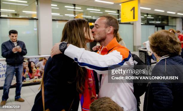 Dutch national football team player Wesley Sneijder is welcomed by his wife Yolanthe Sneijder-Cabau as he arrives at Schiphol Airport in Amsterdam,...