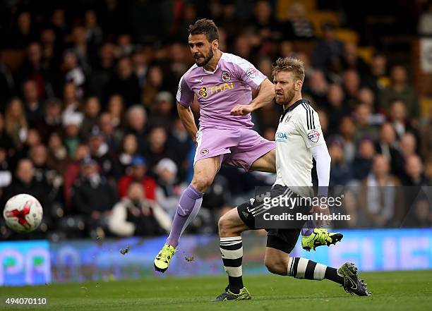 Orlando Sa of Reading scores his team's second goal of the game under pressure from Tim Ream of Fulham during the Sky Bet Championship match between...