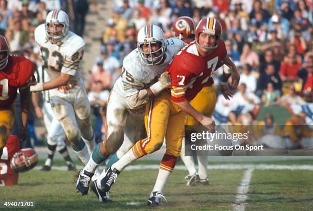 Billy Kilmer of the Washington Redskins gets his pass off under pressure from Manny Fernandez of the Miami Dolphins during Super Bowl VII at the Los...