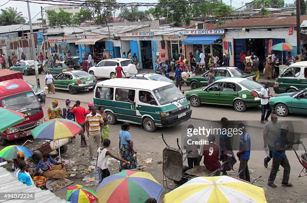 Minibuses wait for passengers on a busy thoroughfare in Brazzaville on October 24 ahead of tomorrow's controversial referendum allowing the longtime...