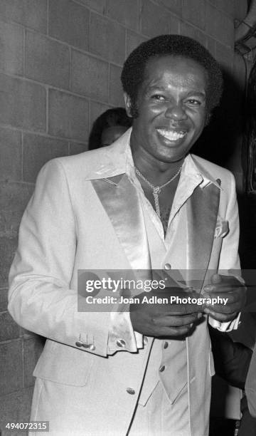 Recording artist and actor Lou Rawls backstage during a tribute to Muhammad Ali celebration at the Forum on September 6, 1979 in Los Angeles,...