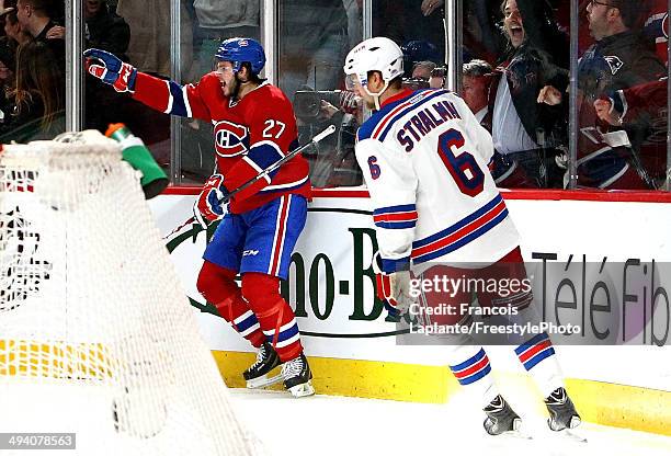 Alex Galchenyuk of the Montreal Canadiens celebrates his first period power play goal as Anton Stralman of the New York Rangers looks on during Game...