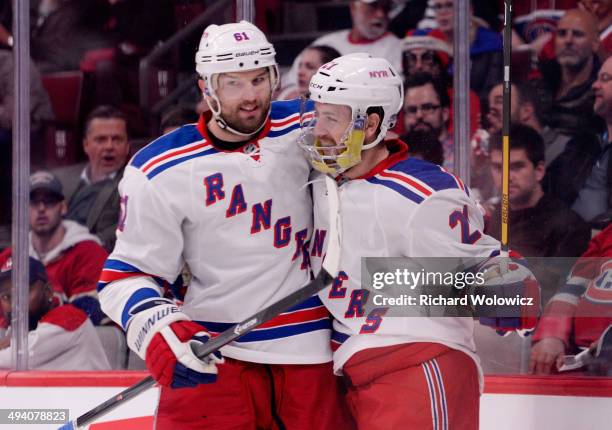 Derek Stepan of the New York Rangers celebrates his first period goal with teammate Rick Nash against the Montreal Canadiens during Game Five of the...