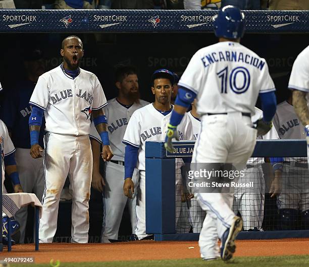 Jose Reyes greets Edwin Encarnacion after he homered as the Toronto Blue Jays play the Tampa Bay Rays at Rogers Centre in Toronto. May 27, 2014.