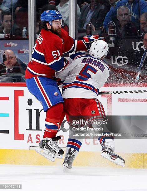 David Desharnais of the Montreal Canadiens and Dan Girardi of the New York Rangers collide along the baords during Game Five of the Eastern...