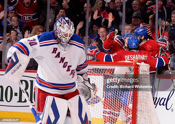 Max Pacioretty of the Montreal Canadiens is mobbed by his teammates after scoring a second period goal at 3:44 as Henrik Lundqvist of the New York...