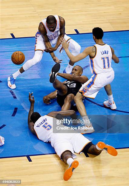 Boris Diaw of the San Antonio Spurs fights for a loose ball with Kendrick Perkins, Kevin Durant and Jeremy Lamb of the Oklahoma City Thunder in the...