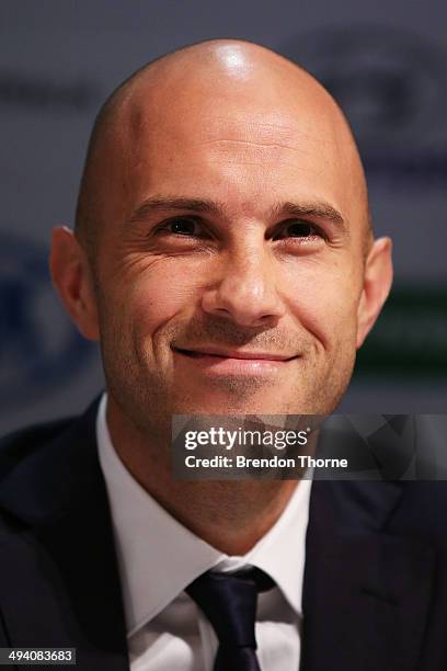Mark Bresciano of Australia speaks to the media prior to departing for Brazil ahead of the 2014 FIFA World Cup, at Sydney International Airport on...