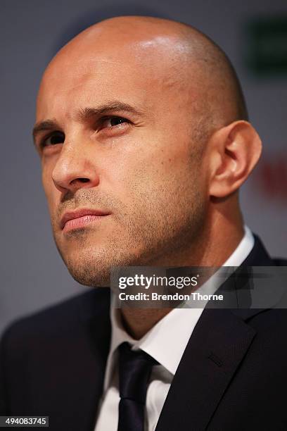 Mark Bresciano of Australia speaks to the media prior to departing for Brazil ahead of the 2014 FIFA World Cup, at Sydney International Airport on...