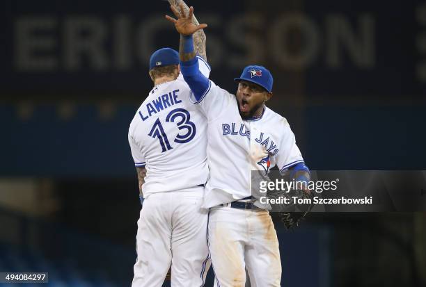 Jose Reyes of the Toronto Blue Jays celebrates their victory with Brett Lawrie during MLB game action against the Tampa Bay Rays on May 27, 2014 at...