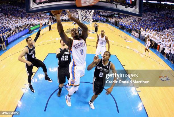 Serge Ibaka of the Oklahoma City Thunder drives to the basket against Kawhi Leonard of the San Antonio Spurs in the first half during Game Four of...