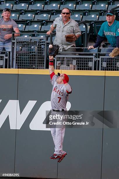 Right fielder Collin Cowgill of the Los Angeles Angels of Anaheim catches a fly ball off the bat of Michael Saunders of the Seattle Mariners in the...