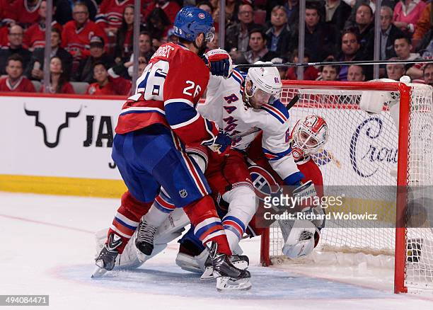 Rick Nash of the New York Rangers crashes into Dustin Tokarski of the Montreal Canadiens during Game Five of the Eastern Conference Final in the 2014...