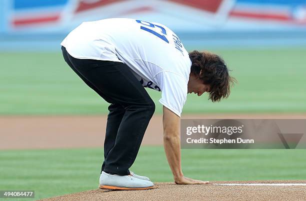 Former Los Angeles Dodgers pitcher Chan Ho Park touches the pitchers mound before throwing out the ceremonial first pitch as part of "Korea Night"...