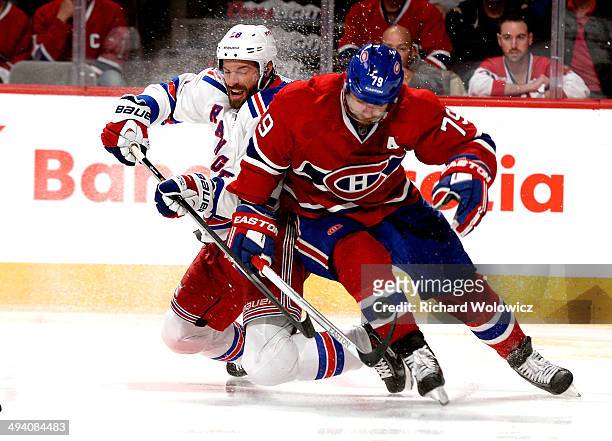 Dominic Moore of the New York Rangers and Andrei Markov of the Montreal Canadiens battle for the puck during Game Five of the Eastern Conference...