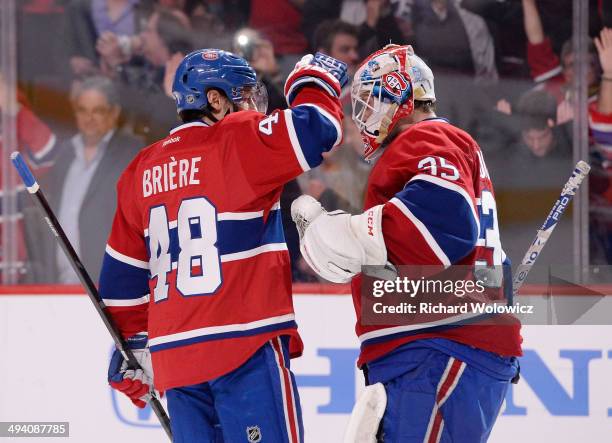 Dustin Tokarski and Daniel Briere of the Montreal Canadiens celebrates after defeating the New York Rangers during Game Five of the Eastern...