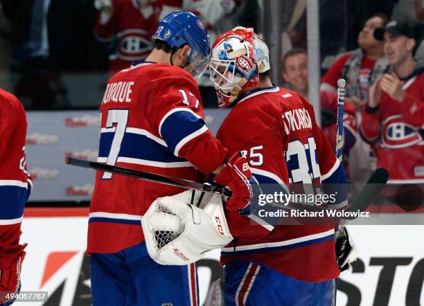 Dustin Tokarski and Rene Bourque of the Montreal Canadiens celebrates after defeating the New York Rangers during Game Five of the Eastern Conference...
