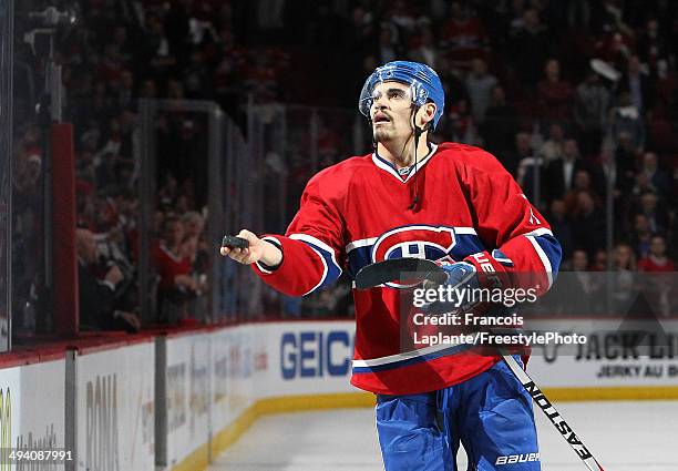 Rene Bourque of the Montreal Canadiens throws a puck in the crowd after recieving the first star of the game against the New York Rangers during Game...